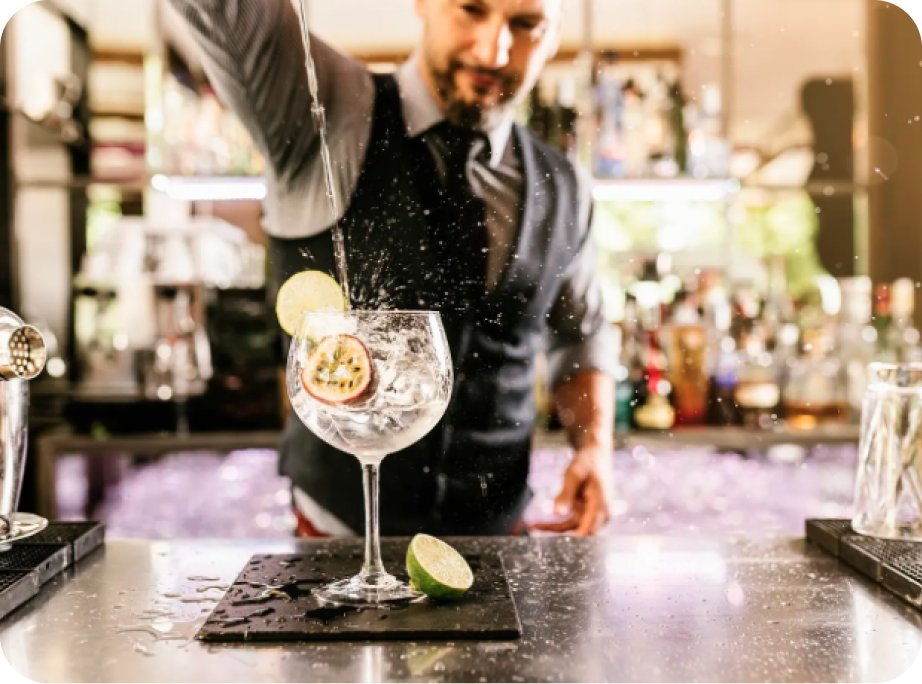 A bartender pouring a Devil&rsquo;s Grin gin and tonic at a bar